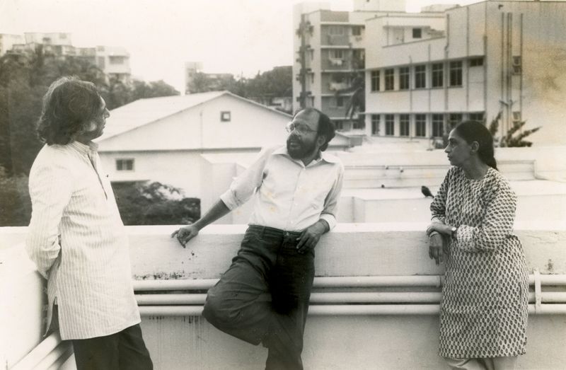 **Pradbodh Parikh, Tyeb Mehta and Sakina Mehta, c.1980s**
Photograph of Prabodh Parikh in conversation with Tyeb Mehta as Sakina Mehta listens on a terrace.
