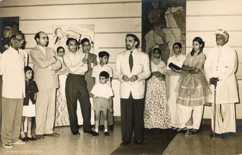 **Ebrahim Alkazi at Tyeb Mehta's Exhibition, in 1959, Gallery 59**
Photograph of capturing Ebrahim Alkazi delivering a speech at Tyeb Mehta's exhibition organised by Gallery 59, Bombay, in 1959. The image also features Tyeb Mehta and Bal Chhabda.
