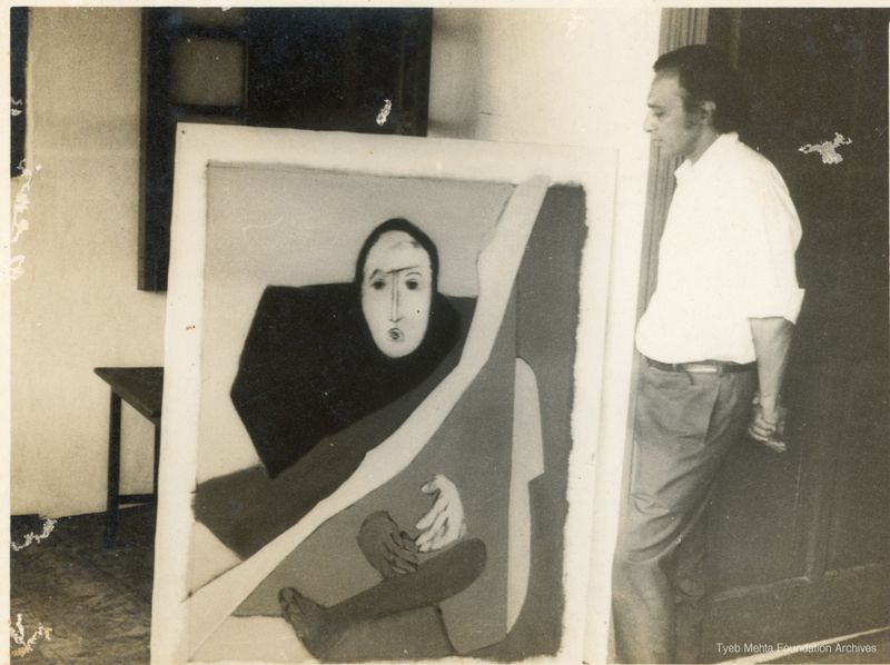 **Tyeb Mehta standing by Diagonal series, c. 1960s - 1970s**
Photograph of Tyeb Mehta standing by a canvas of a painting from his 'Diagonal' series.